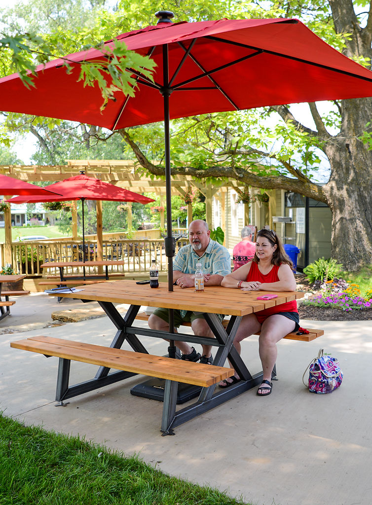 From left, Jim Green and Michelle Green finish lunch Saturday in the new outdoor seating area at the Pierpont Café and Bar